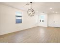 Well-lit dining area with a modern chandelier and tile flooring at 4324 W Jeanette Ln, San Tan Valley, AZ 85144