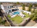 Aerial view showcasing the home's backyard with a pool, firepit, seating, and landscaping at 5139 S Bridal Vail Dr, Gilbert, AZ 85298