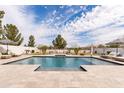 Backyard swimming pool offers in-water seating, built-in lighting, and ample space for sunbathing or entertaining at 5139 S Bridal Vail Dr, Gilbert, AZ 85298