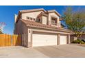 Exterior view of home featuring a three car garage, desert landscaping, and tile roof at 5356 W Jupiter Way, Chandler, AZ 85226