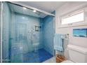 Bright blue tiled walk-in shower with glass doors and built-in bench seating at 592 Leisure World --, Mesa, AZ 85206