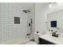 The bathroom has white subway tile, black hardware, and dark blue vanity with a white countertop at 6009 N 79Th St, Scottsdale, AZ 85250