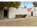 The exterior of this condo shows a lovely unit with a secure front door and landscaped yard at 6009 N 79Th St, Scottsdale, AZ 85250