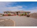 Single story stucco home featuring circular driveway and tiled roof at 6786 W Appaloosa Trl, Coolidge, AZ 85128