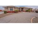 Single story stucco home featuring circular driveway and tiled roof at 6786 W Appaloosa Trl, Coolidge, AZ 85128