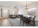 Bright living room with a dining area featuring neutral tones and natural light at 6890 W Remuda Dr, Peoria, AZ 85383