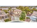 An aerial view of a home with a tile roof, mature landscaping, and a brick-paved drive in a suburban neighborhood at 7010 S San Jacinto Ct, Gilbert, AZ 85298