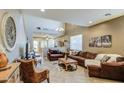 Inviting living room features high ceilings, tiled floors, a large window, and plush, comfortable furniture at 7010 S San Jacinto Ct, Gilbert, AZ 85298