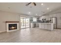 Open-concept living space with fireplace, sliding glass doors, and kitchen with stainless steel appliances at 726 E Aire Libre Ave, Phoenix, AZ 85022