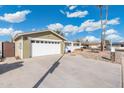 View of front yard, two car garage, driveway and well-maintained rock landscaping at 790 N Meadows Dr, Chandler, AZ 85224