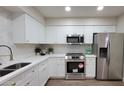 Bright kitchen featuring white cabinetry, stainless steel appliances, and a sleek, modern design at 7950 E Keats Ave # 150, Mesa, AZ 85209