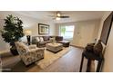 Cozy living room showcasing a gray sectional, soft area rug, and a bright window for natural light at 7950 E Keats Ave # 150, Mesa, AZ 85209