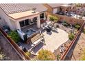 Inviting backyard featuring a hot tub, covered patio, and desert landscaping at 8142 S Open Trail Ln, Gold Canyon, AZ 85118