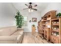 Office with a wooden desk set, tan couch, light-colored hardwood floors and a window at 8142 S Open Trail Ln, Gold Canyon, AZ 85118