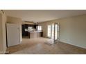 A view of the kitchen featuring dark cabinets, white appliances, and an airy atmosphere at 8815 W Columbus Ave, Phoenix, AZ 85037