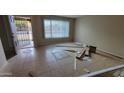 Bright living room with tile flooring, a large window, and an open entryway for a spacious feel at 8815 W Columbus Ave, Phoenix, AZ 85037