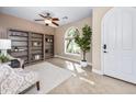 Bright home office features arched window, ceiling fan, and built-in shelving units at 964 S Henry Ln, Gilbert, AZ 85296