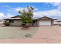 Inviting single-story home with a two-car garage, xeriscape yard, and a sizable driveway for parking at 9703 W Forrester Dr, Sun City, AZ 85351