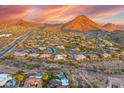 Aerial view of the neighborhood and homes against a backdrop of stunning mountain scenery at 10396 N 133Rd St, Scottsdale, AZ 85259