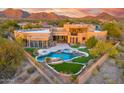 Resort-style backyard with pool, spa, and lush landscaping with mountain views at 10396 N 133Rd St, Scottsdale, AZ 85259