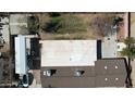 Aerial view of the property showing the roof and backyard with a grassy area at 1216 N 66Th Pl, Mesa, AZ 85205