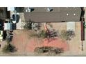 Aerial view of the home's roof and hardscaped backyard with a concrete patio and red-paved lounge area at 1216 N 66Th Pl, Mesa, AZ 85205