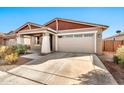 Inviting one-story home with a well-manicured yard and attached two-car garage at 1243 E Glass Ln, Phoenix, AZ 85042