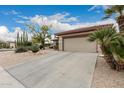 Charming desert home featuring low-maintenance landscape with cacti and a concrete driveway at 15022 W Cooperstown Way, Surprise, AZ 85374