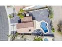 An aerial view of a home highlighting the distinct tile roof and freeform swimming pool at 15039 S 28Th St, Phoenix, AZ 85048