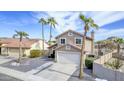 Two-story home featuring palm trees, desert landscaping, a two-car garage, and a red-tiled roof in a sunny neighborhood at 15039 S 28Th St, Phoenix, AZ 85048