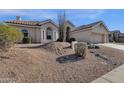 Charming single-story home featuring a tile roof, desert landscaping, and a two-car garage at 1635 E Silverwood Dr, Phoenix, AZ 85048