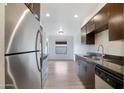 Modern kitchen featuring stainless steel appliances, dark cabinetry, and granite countertops at 16657 E Gunsight Dr # 233, Fountain Hills, AZ 85268