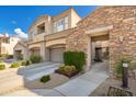 Townhouse with a desert landscape, a front yard, and a two-car garage at 19475 N Grayhawk Dr # 2119, Scottsdale, AZ 85255