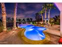 Sparkling pool with elegant patio, palm trees, and inviting outdoor seating area at 22329 N Padaro Dr, Sun City West, AZ 85375