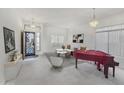 Inviting living room featuring a decorative front door and a grand piano at 22436 N 48Th St, Phoenix, AZ 85054