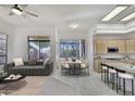 Open-concept living space with dining area, kitchen, and comfortable seating at 22436 N 48Th St, Phoenix, AZ 85054