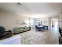 Bright living room featuring wood floors, a comfortable couch and seating, and an open floor plan at 22927 N 41St St, Phoenix, AZ 85050