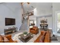 Bright, open living room featuring high ceilings, cozy leather furniture, and view of staircase at 2340 W Myrtle Dr, Chandler, AZ 85248