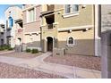 View of townhome with a covered entryway, desert landscaping, and multiple levels of living space at 2402 E 5Th St # 1521, Tempe, AZ 85288