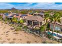 Aerial view of backyard with desert landscaping, covered patio, pool and desert mountain views at 29412 N 128Th Ln, Peoria, AZ 85383