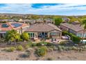 Aerial shot showcases the home's backyard with outdoor seating, spa, and well-maintained landscaping at 29412 N 128Th Ln, Peoria, AZ 85383