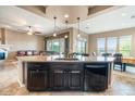 Open-concept kitchen with granite countertops and stainless steel appliances at 29412 N 128Th Ln, Peoria, AZ 85383