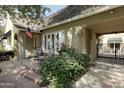 Inviting covered porch with comfortable seating and mature landscaping offer a relaxing outdoor space at 34 W Vernon Ave, Phoenix, AZ 85003