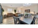 Open-concept dining area with a large table, modern decor, and ample natural light at 3716 E Andre Ave, Gilbert, AZ 85298