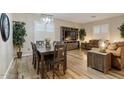 Cozy living room with wood floors, a dining area, and comfortable seating at 3716 E Andre Ave, Gilbert, AZ 85298