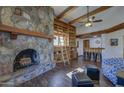 Comfortable living room featuring a stone fireplace, bookshelves, and cozy seating at 40445 N 32Nd St, Cave Creek, AZ 85331