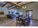 Open living area with wood beams, tile flooring, and comfortable leather seating at 40445 N 32Nd St, Cave Creek, AZ 85331
