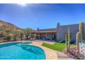 Backyard pool and spa area featuring desert landscaping and an outdoor living space at 40445 N 32Nd St, Cave Creek, AZ 85331