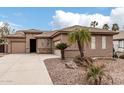 Beautiful home with a well-maintained yard, palm trees, stone accents, and a spacious driveway at 4159 E Shannon St, Gilbert, AZ 85295