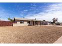A lovely home with a spacious front yard, featuring a covered porch and easy-care desert landscaping at 4813 N 62Nd Ave, Phoenix, AZ 85033